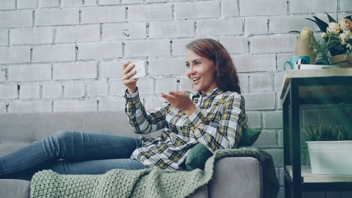 Woman on a video call on her smartphone at home